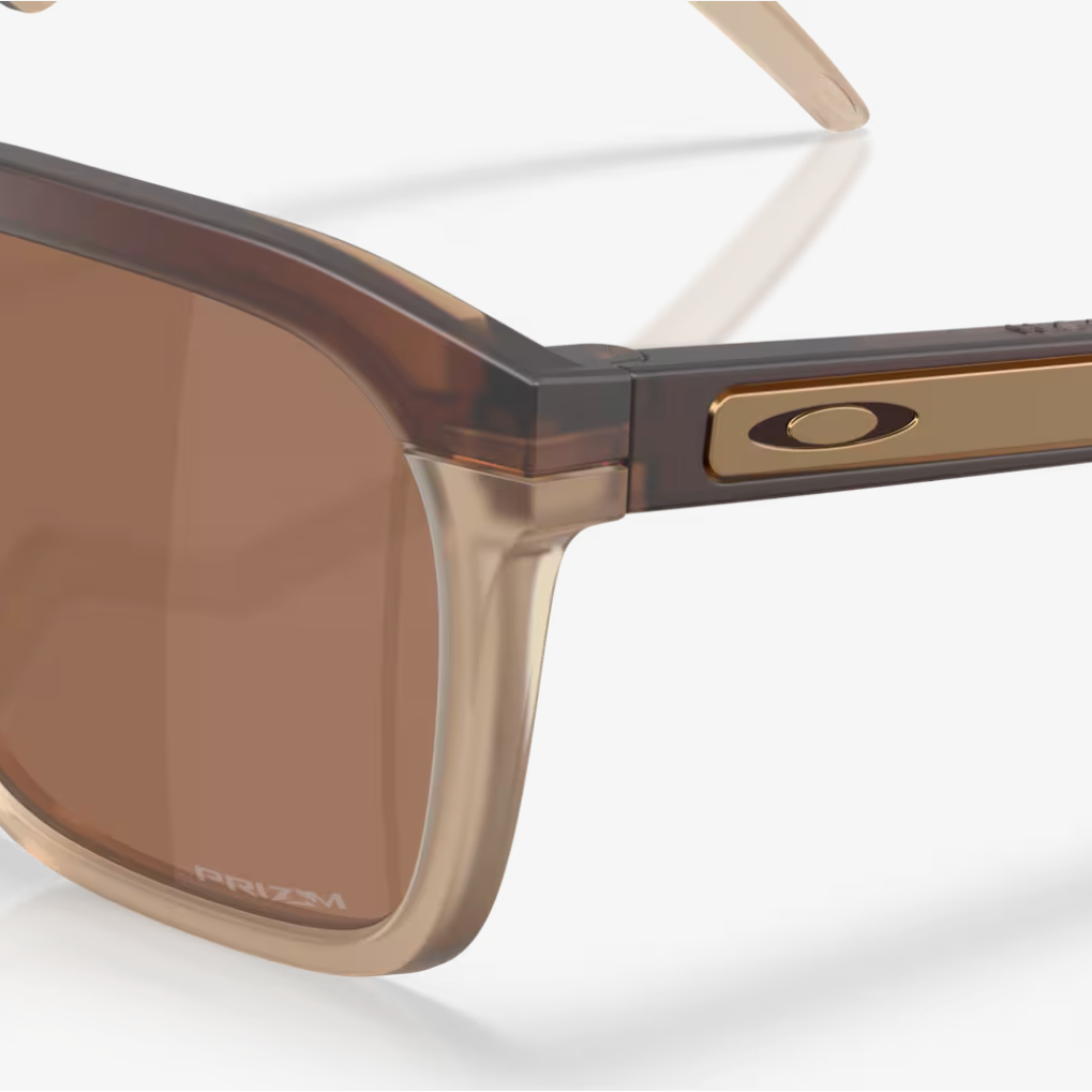 Sunglasses with a brown lens and gold frame on a white background