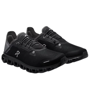 Black running shoes on a light gray background