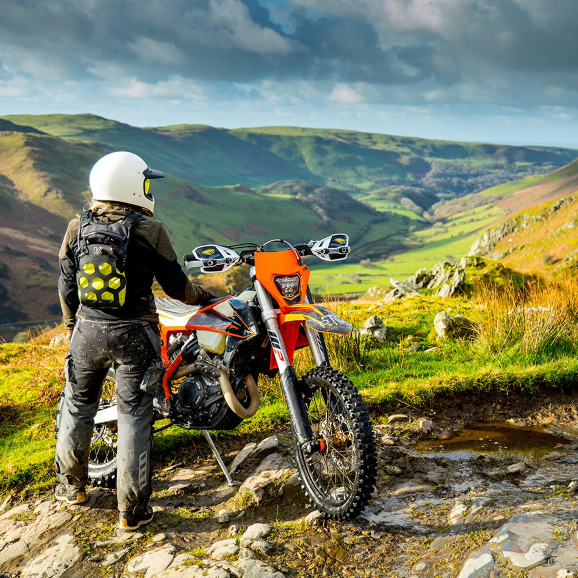 Person with a motorcycle in a scenic mountainous area