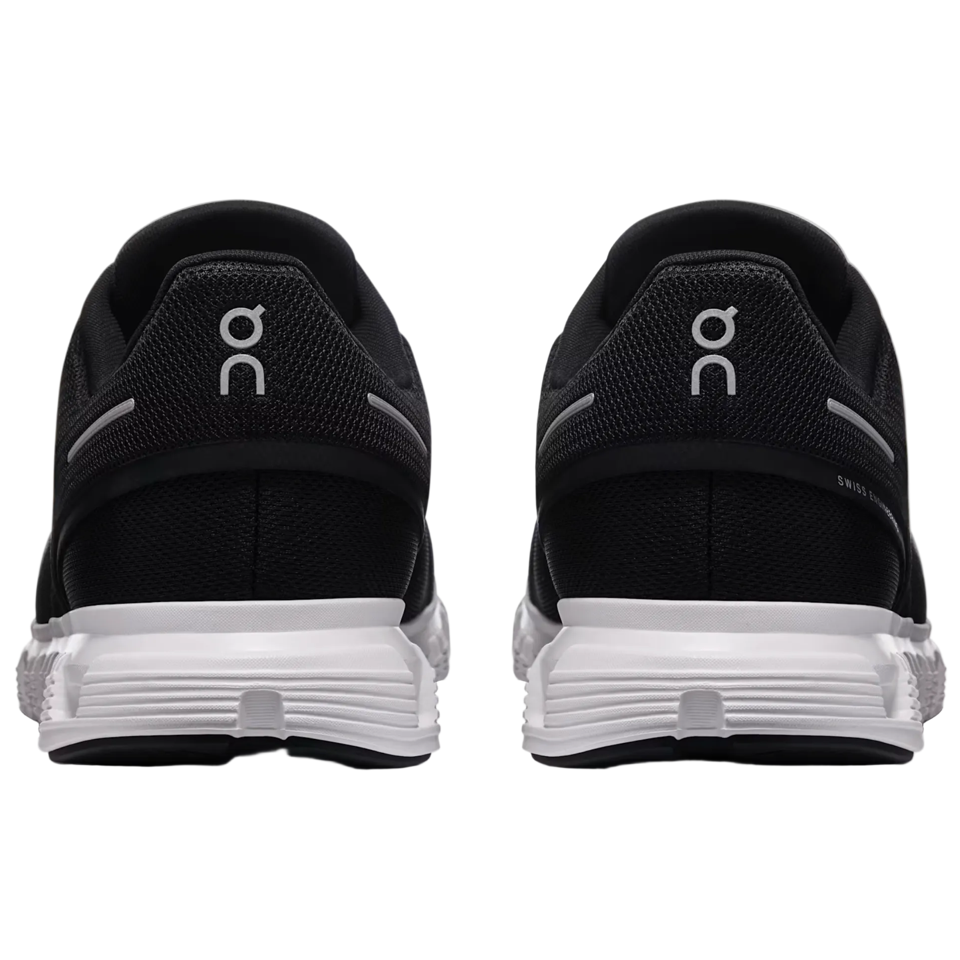 Black running shoes with white sole on a light gray background