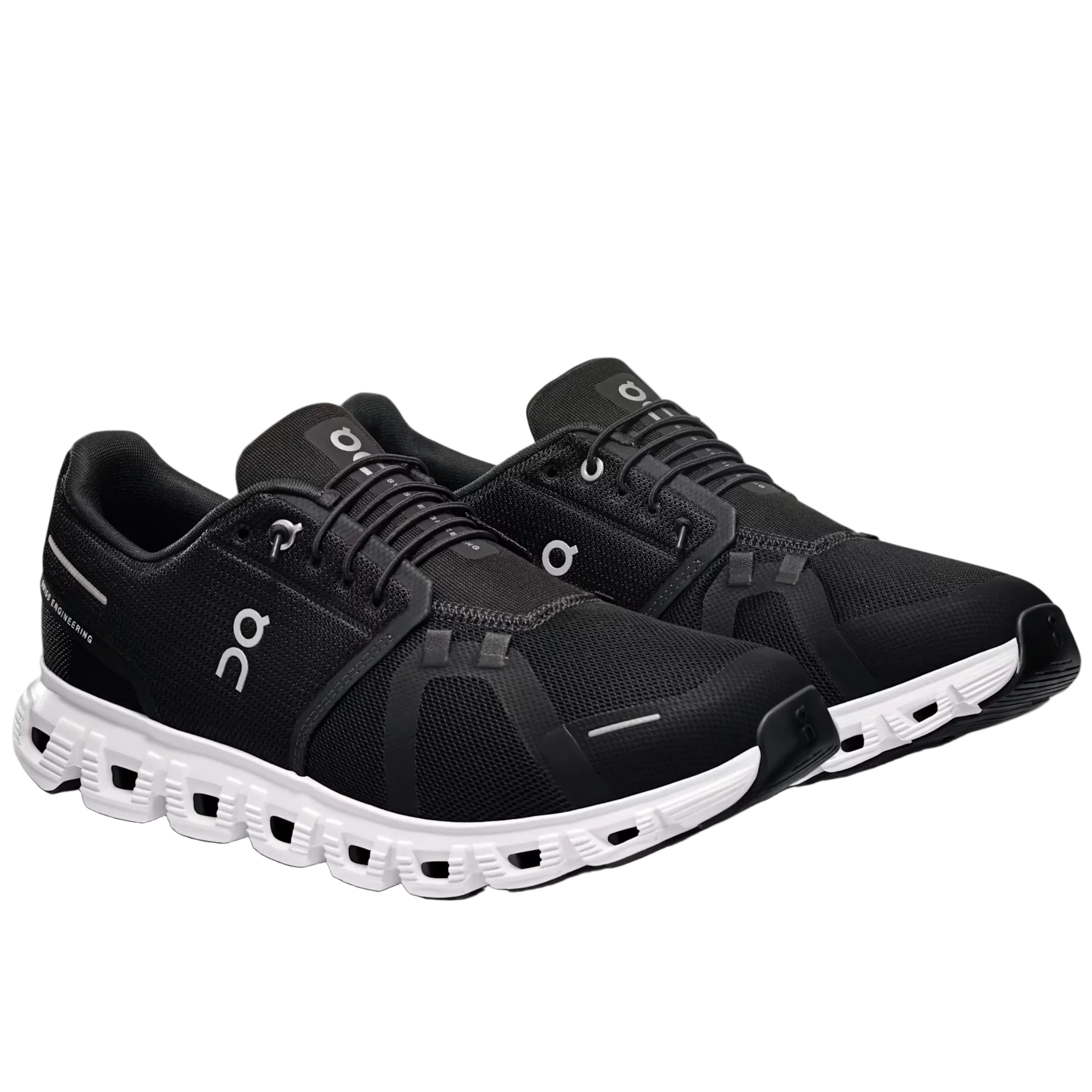 Black running shoes with white soles on a light gray background