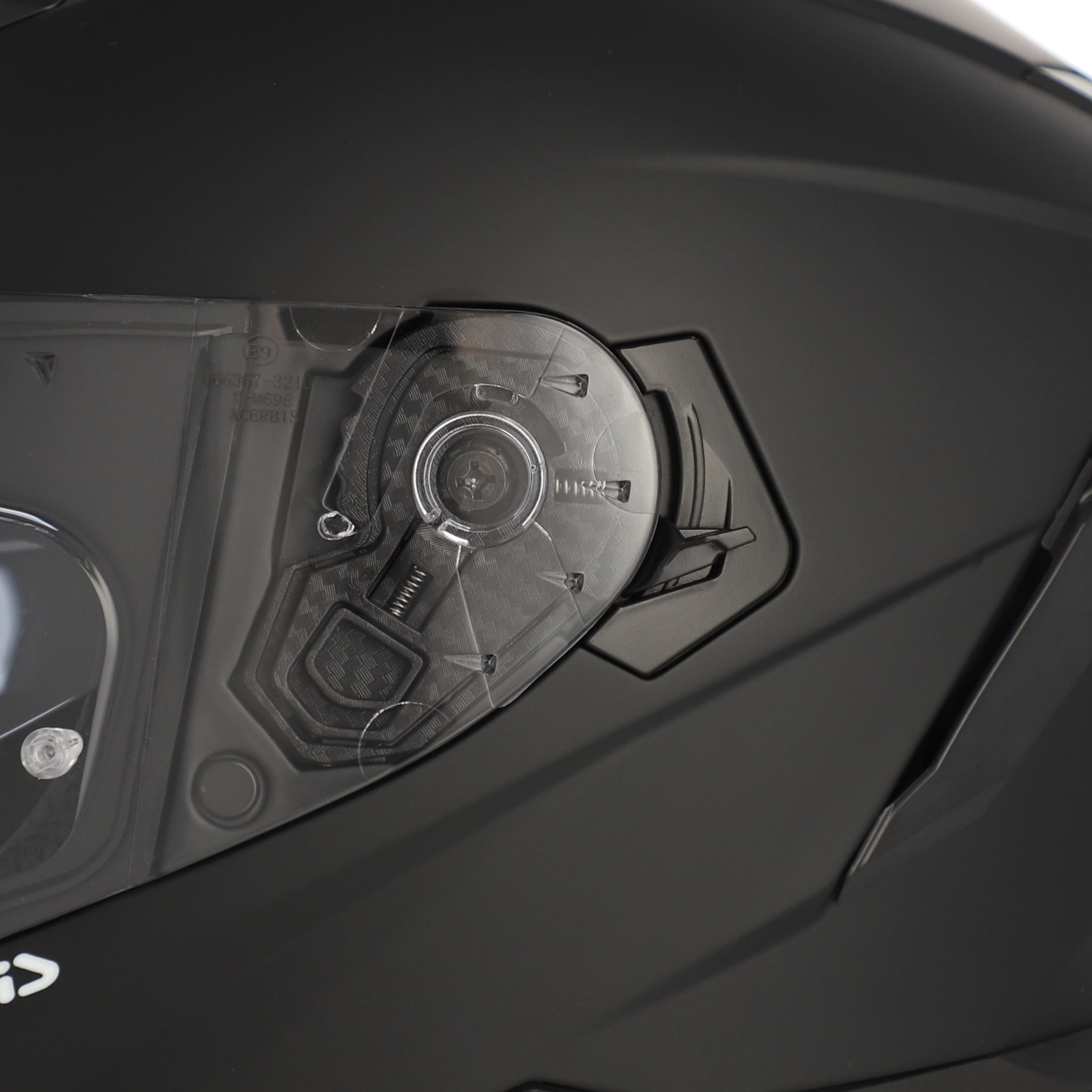 Close-up of a motorcycle helmet with a visor and brand logo.