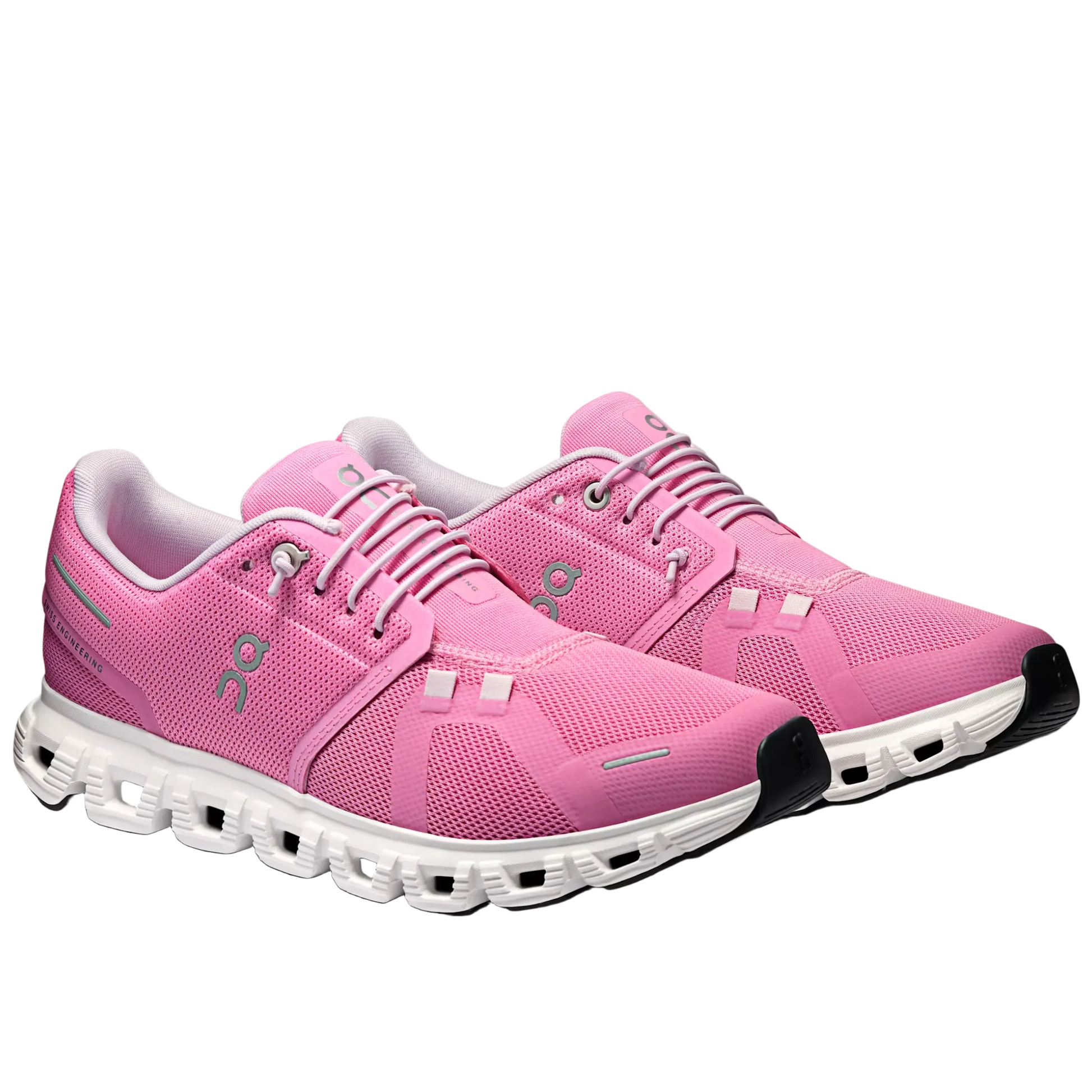 Pink running shoes with white soles on a gray background