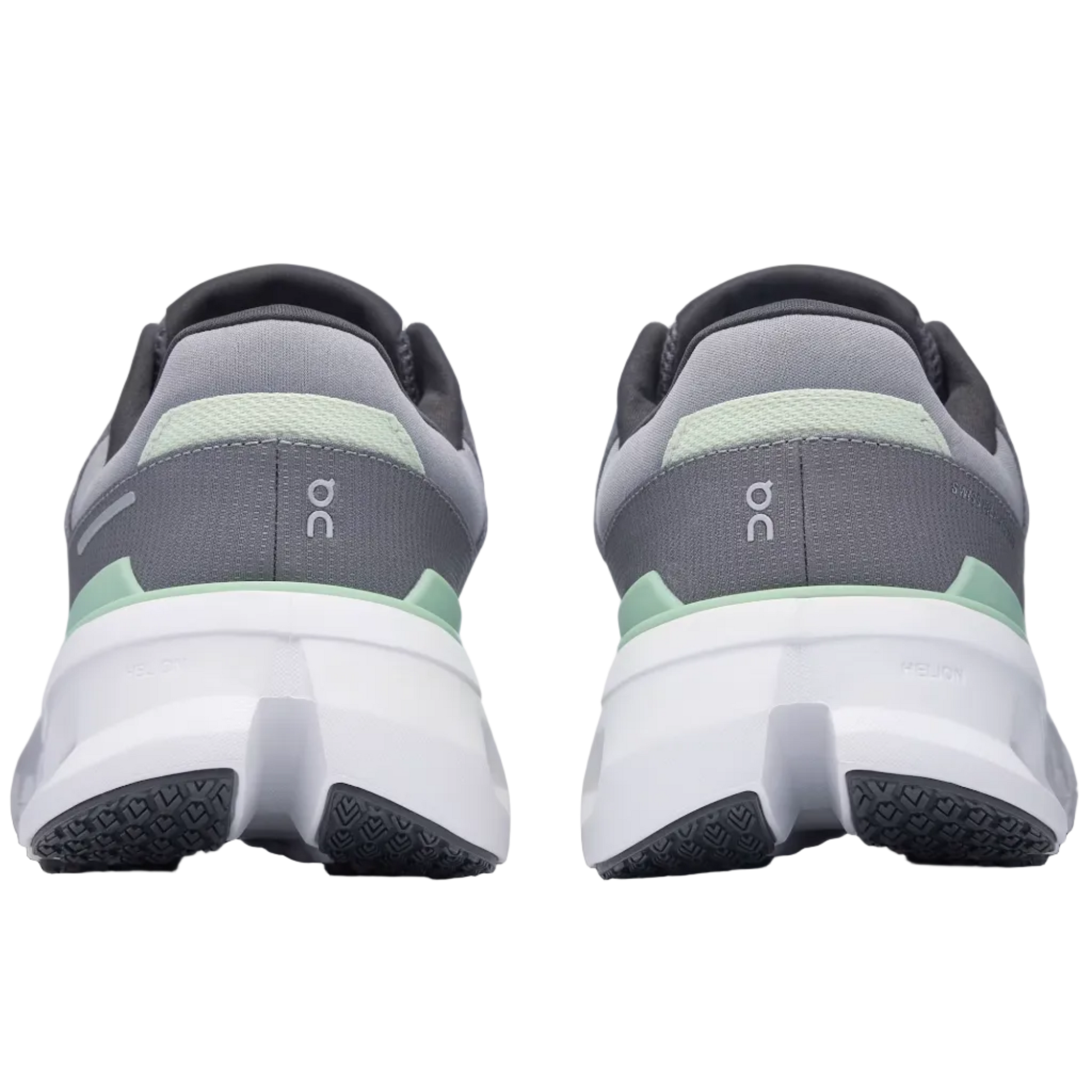 Gray and green running shoes on a light gray background