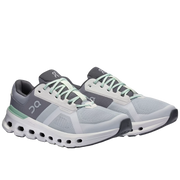 Gray and white running shoes with green accents on a white background