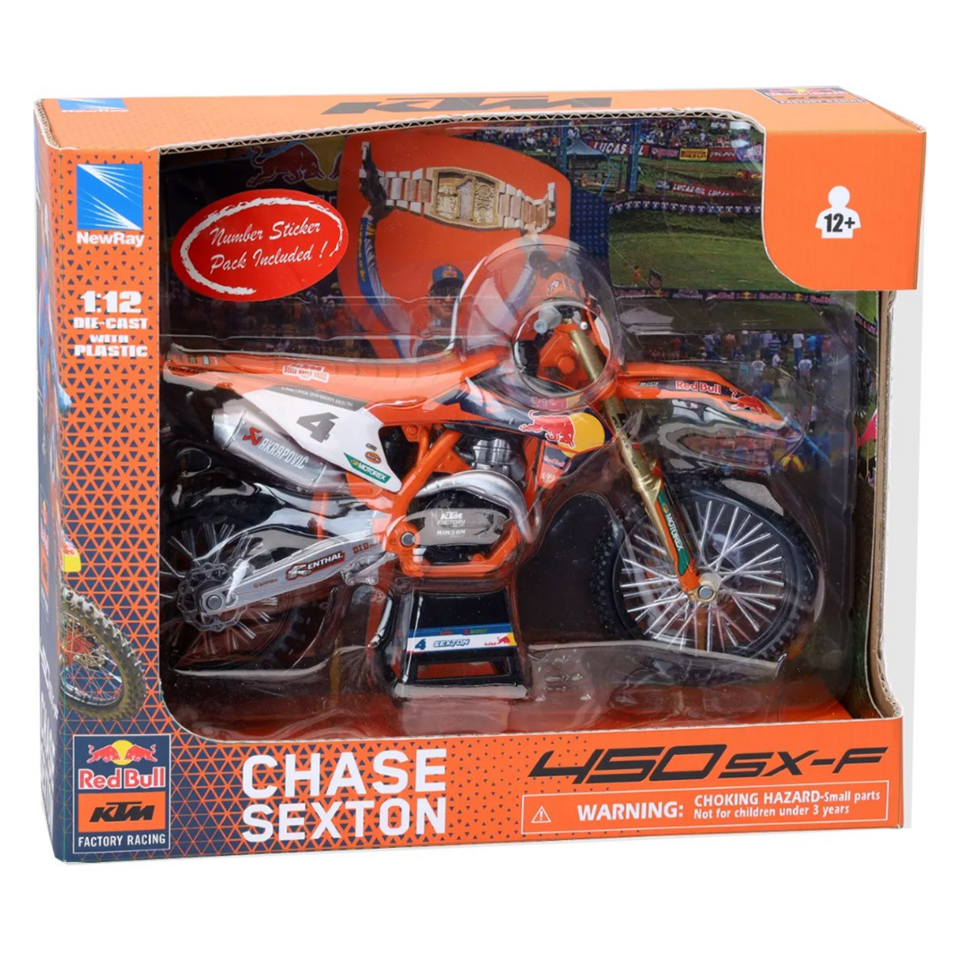 A boxed die-cast toy motorcycle set featuring an orange and white dirt bike with a clear windshield, displayed inside retail packaging with Red Bull, KTM, and Factory Racing branding.