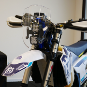 Close-up of a motorcycle with visible branding on a blurred background