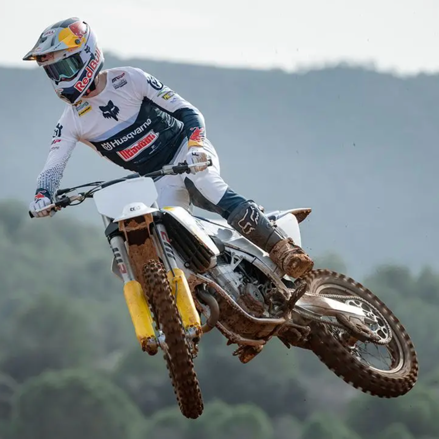 Motorcycle rider in mid-air with a scenic background