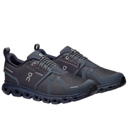 A pair of On running shoes in dark gray and navy blue, displayed on a light gray background.