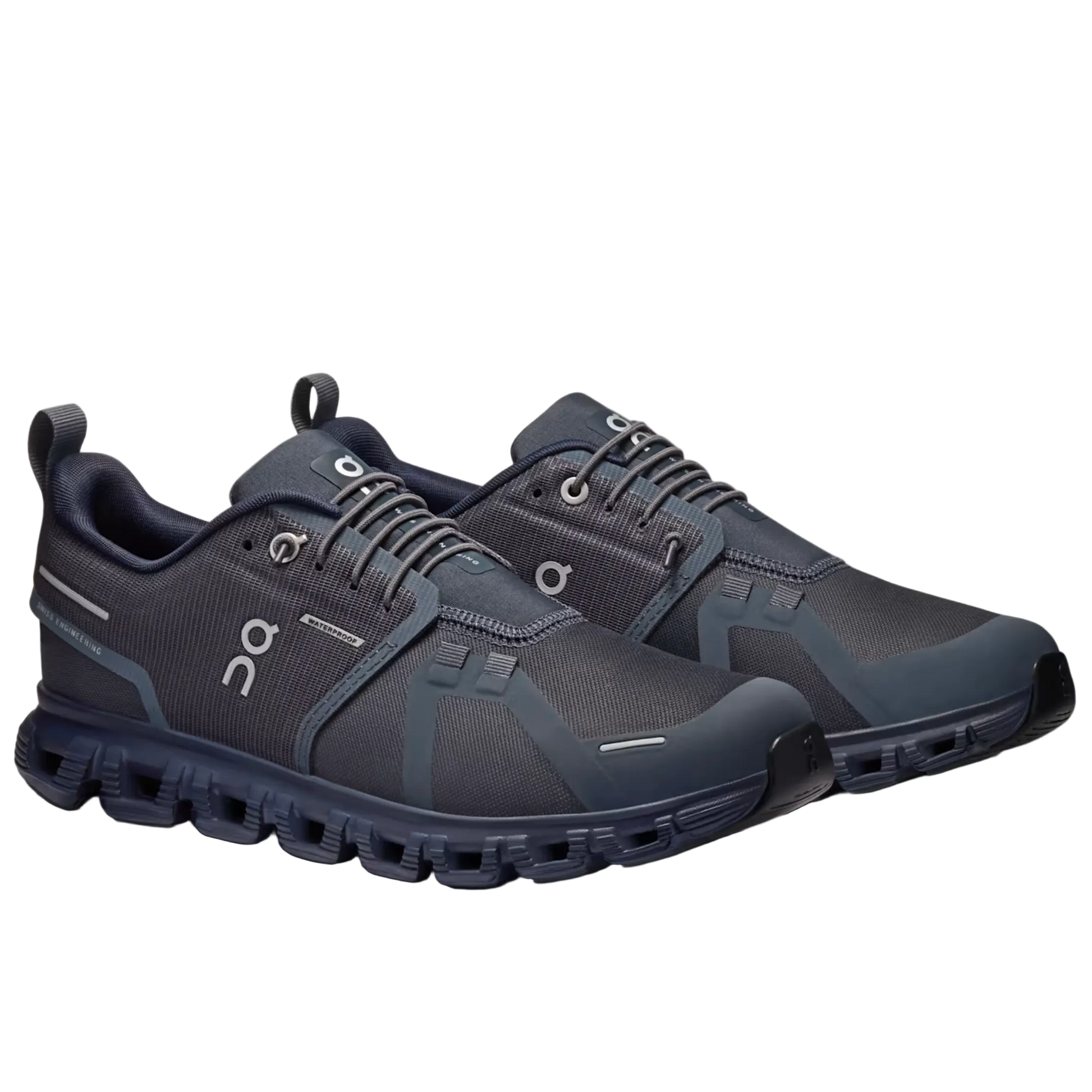 A pair of On running shoes in dark gray and navy blue, displayed on a light gray background.