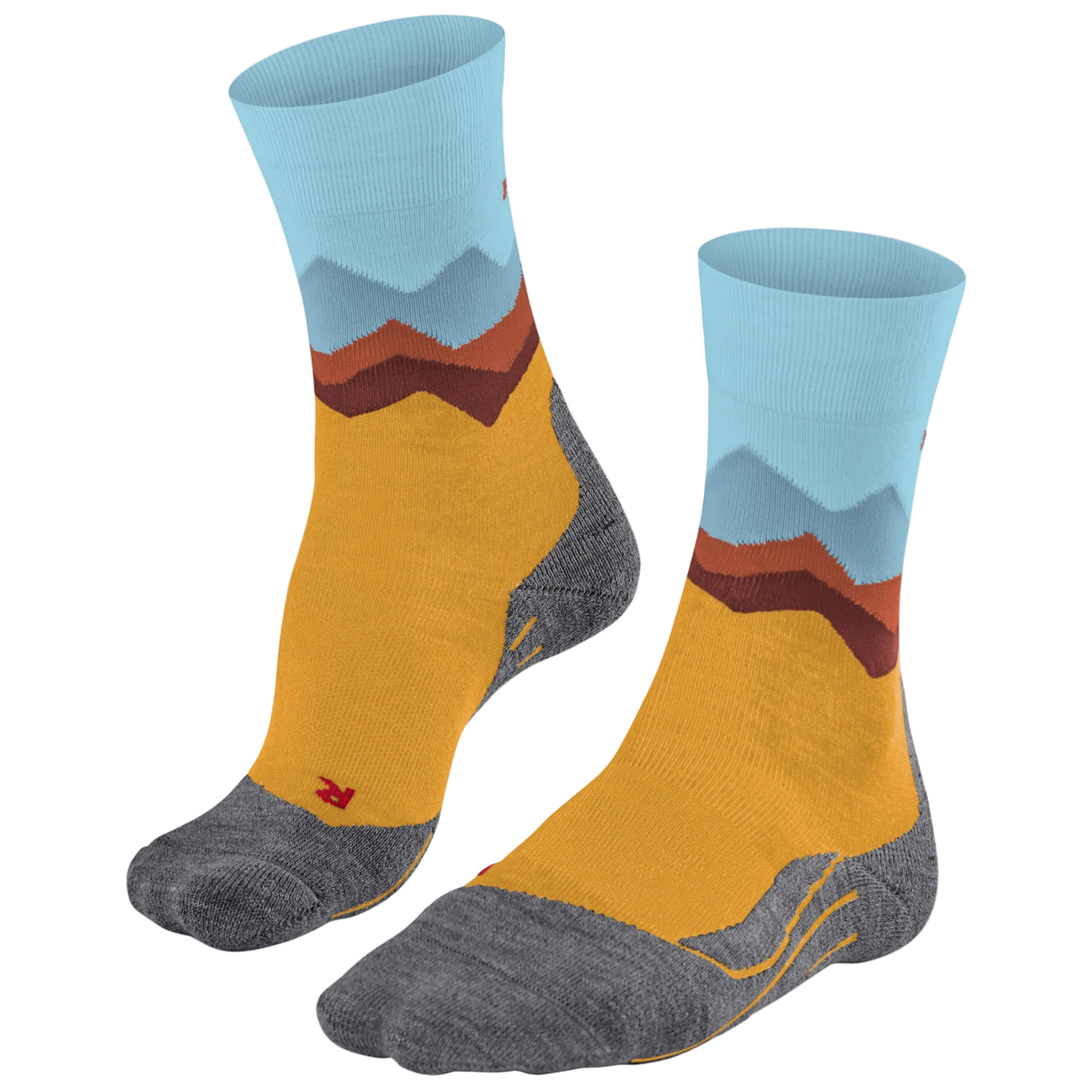 A pair of crew socks with a mountain landscape pattern, featuring a mustard yellow body, gray toe and heel areas, and light blue and brown mountain peaks on the cuff.