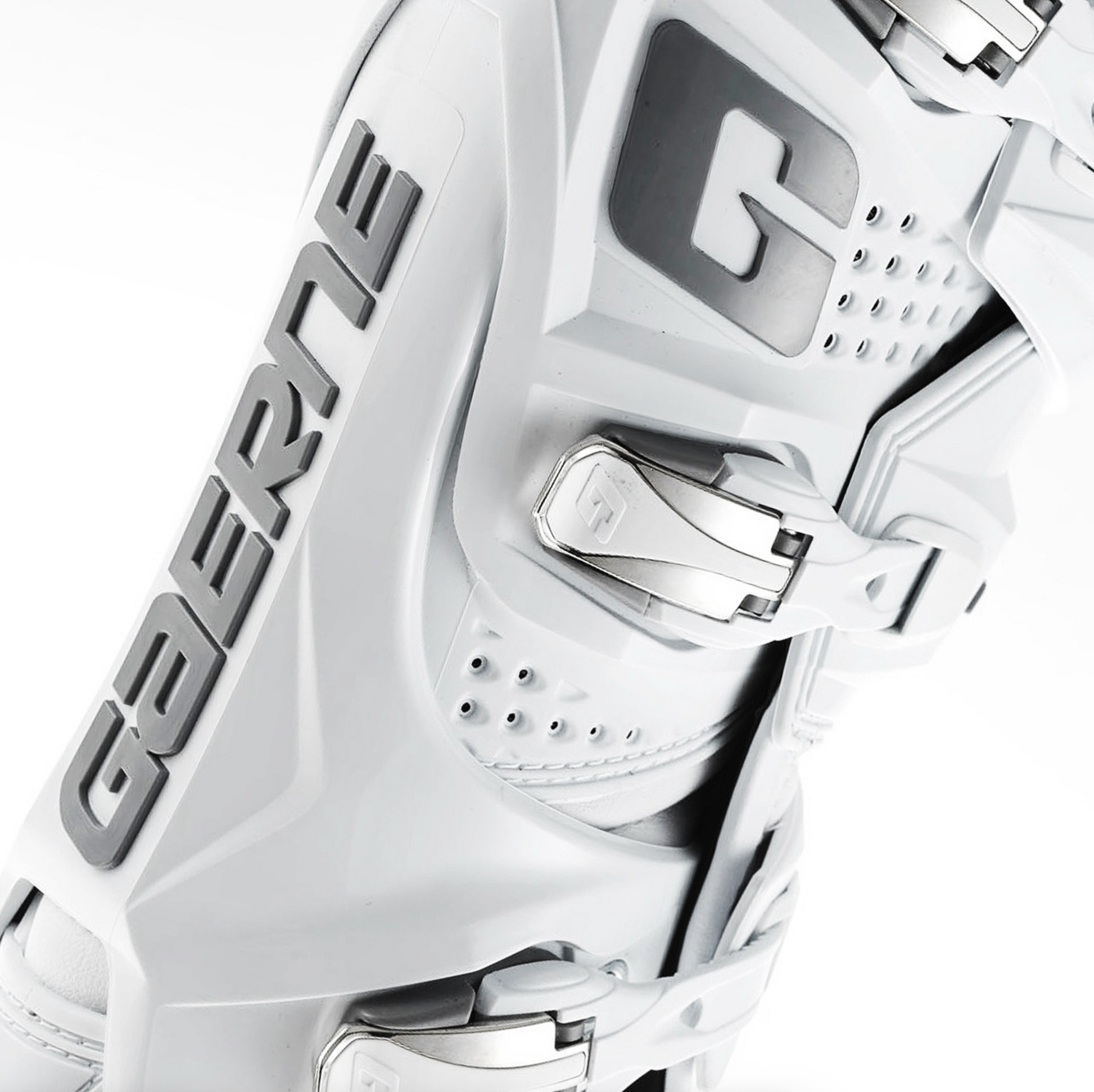 A close-up of a white ski boot with gray branding and silver buckle hardware, photographed on a clean white background.